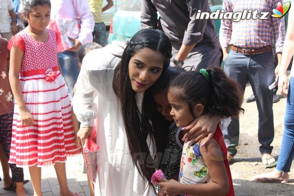 Poonam Pandey Distributes Raincoat To Needy Kids